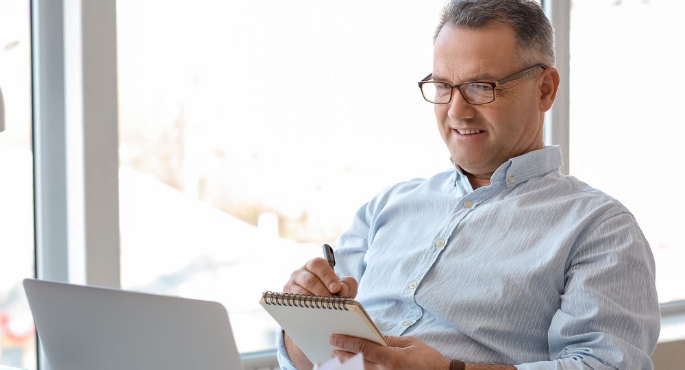 Mature,Man,Using,Laptop,At,Home