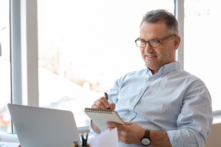 Mature,Man,Using,Laptop,At,Home